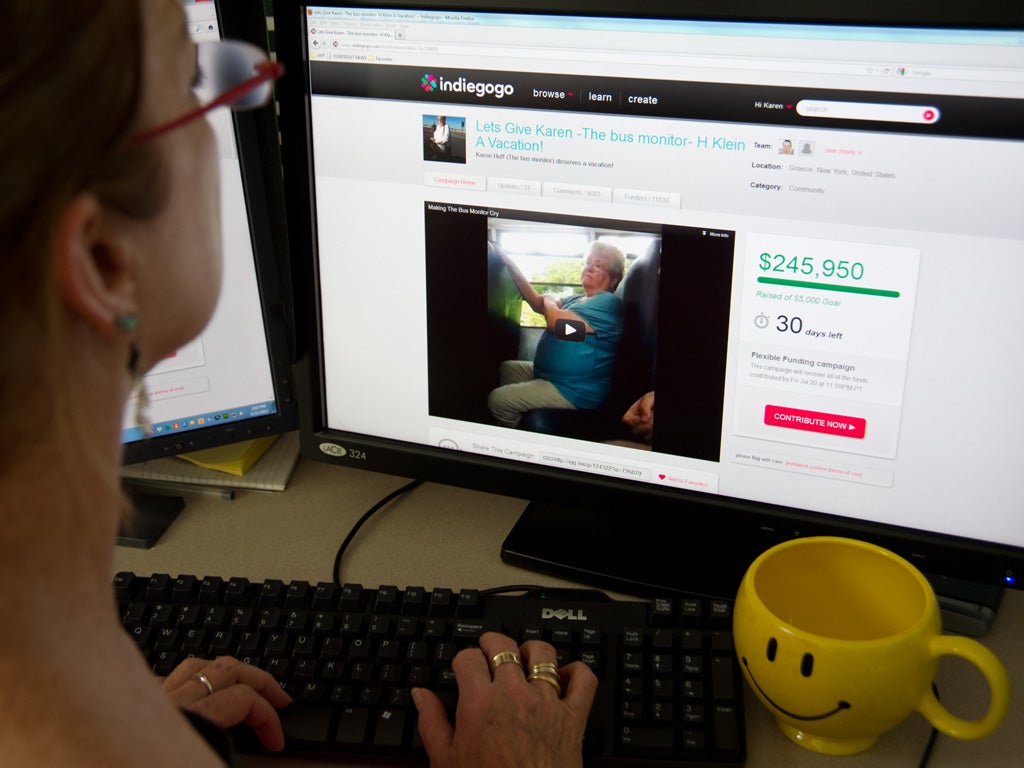 A journalist looks at the website raising money for Karen Klein,an upstate New York school bus monitor