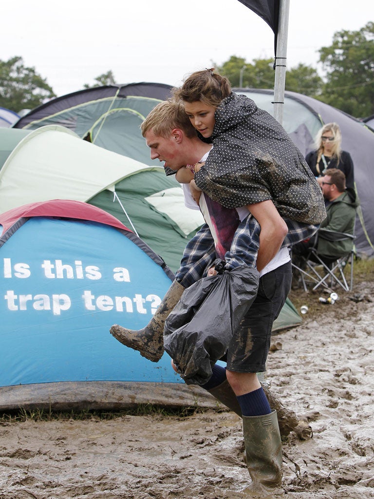 Festival goers brave the mud and high winds at the Isle of Wight Festival yesterday