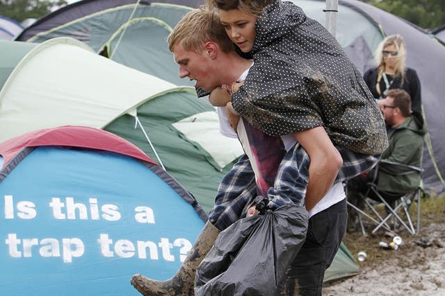 Festival goers brave the mud and high winds at the Isle of Wight Festival yesterday