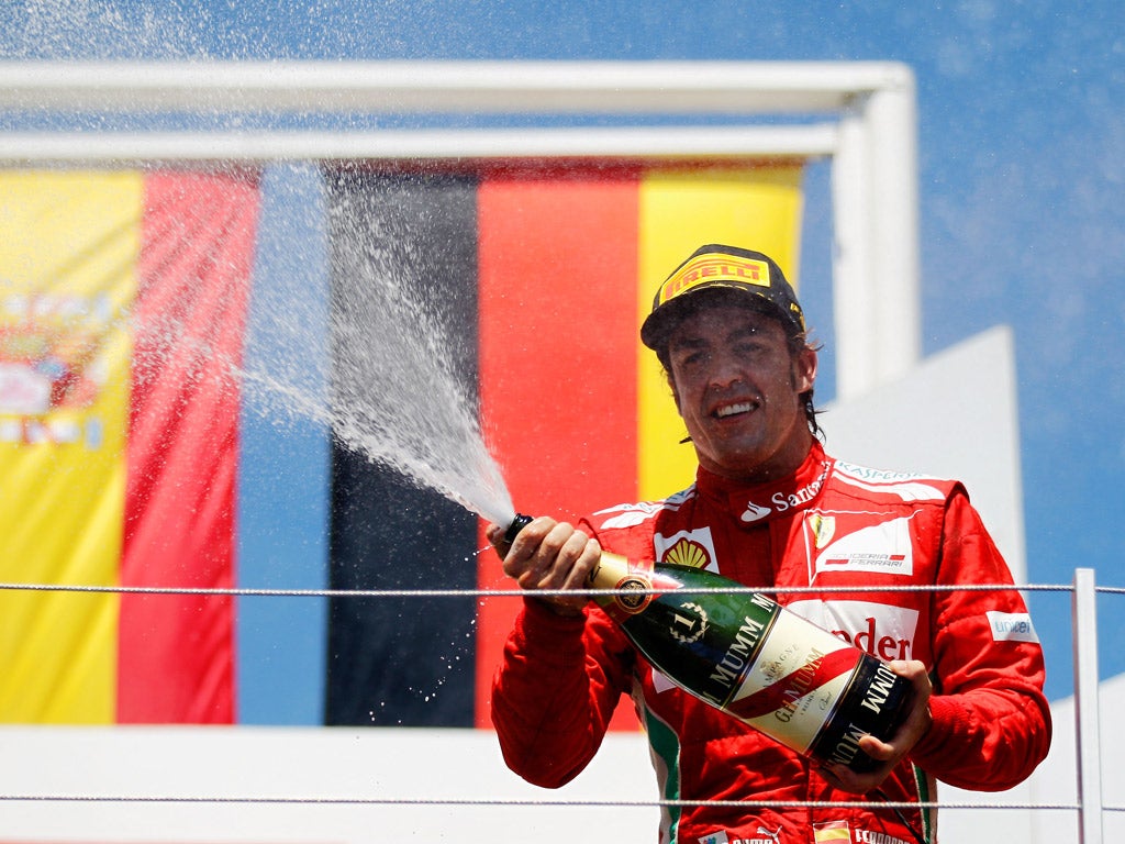 Fernando Alonso of Ferrari celebrates his European Grand Prix win in style