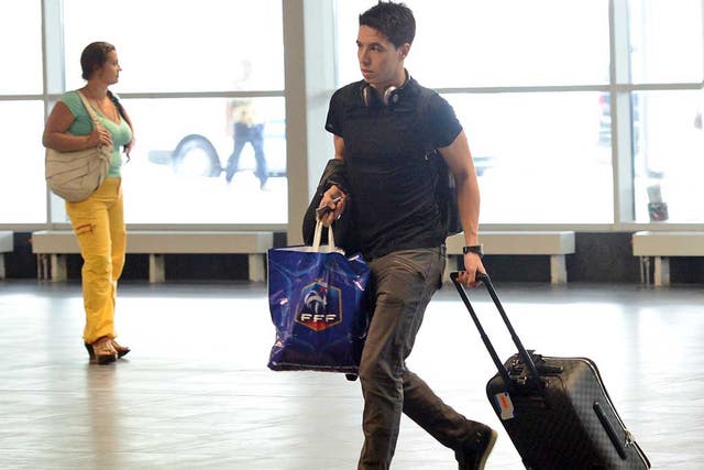 Bags packed: Samir Nasri on his way back to Paris yesterday