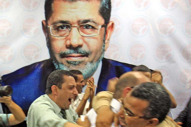 Muslim Brotherhood supporters celebrate Mr Morsi’s victory