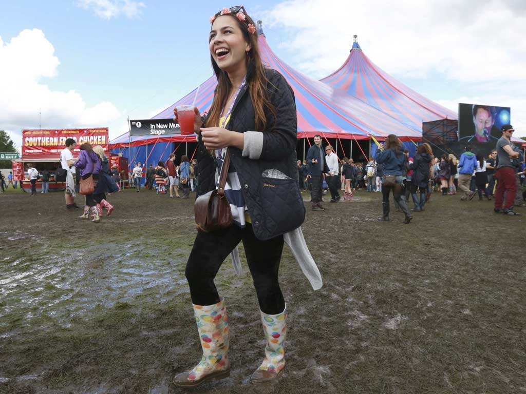 Festival goers walk through the mud at the Hackney Weekender festival at Hackney Marshes in east London