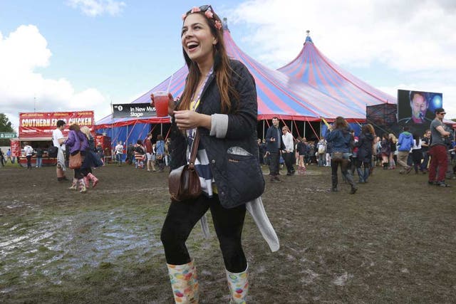 Festival goers walk through the mud at the Hackney Weekender festival at Hackney Marshes in east London