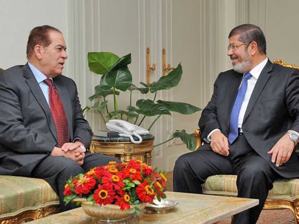 President-elect Mohamed Morsi, right, meeting Prime Minister Kamal al-Ganzuri yesterday