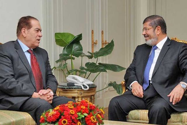 President-elect Mohamed Morsi, right, meeting Prime Minister Kamal al-Ganzuri yesterday