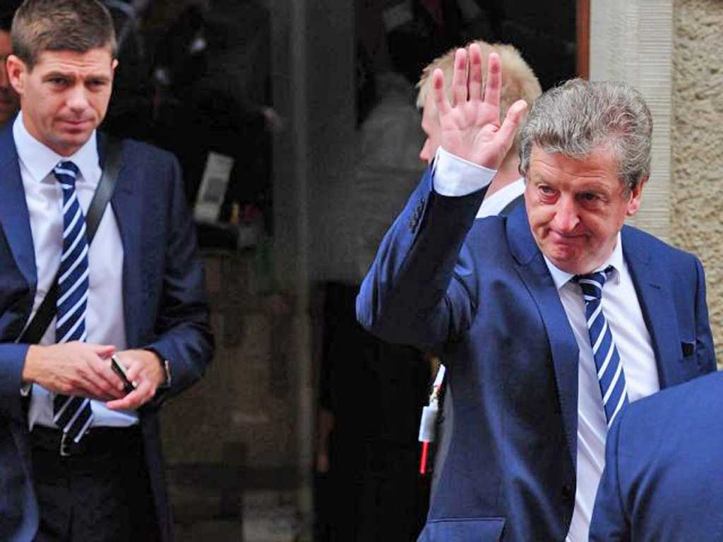 Roy Hodgson, with Steven Gerrard behind him, waves as England leave Poland