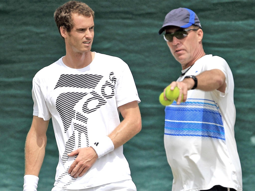 Andy Murray listens to coach Ivan Lendl during a practice session at Wimbledon yesterday