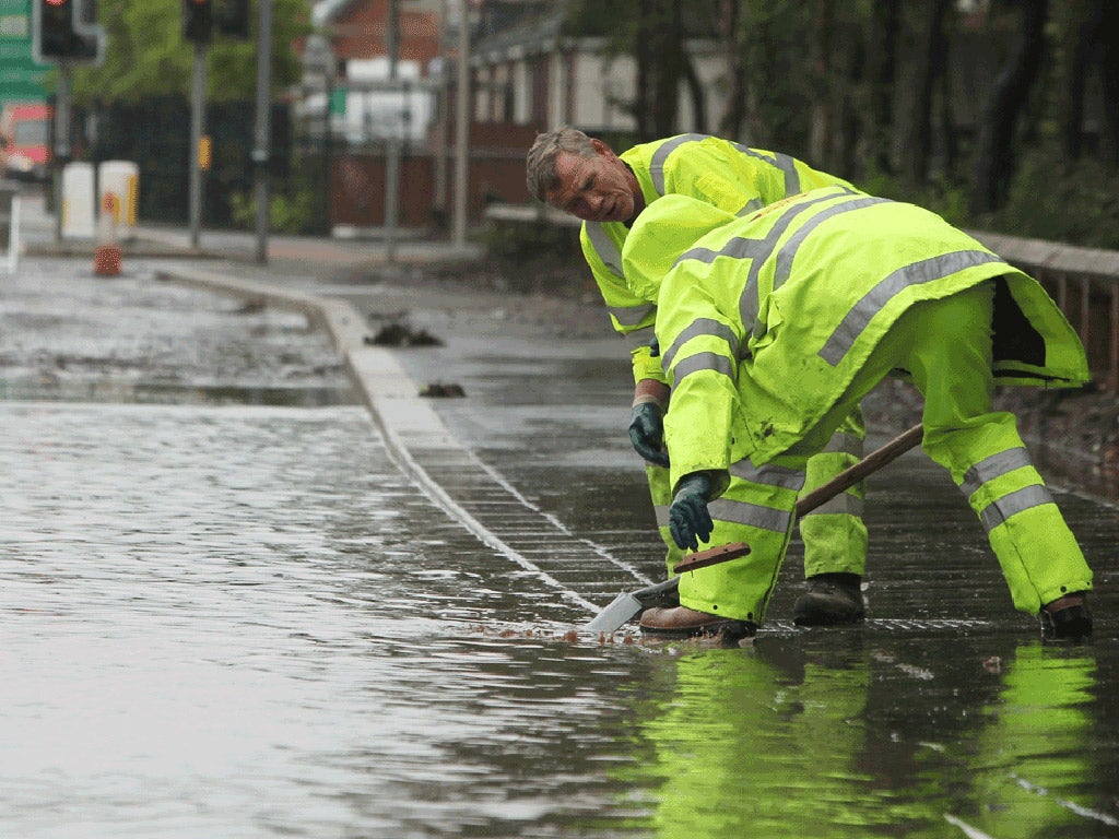 Council workers try to clear blocked drains as flood water settles