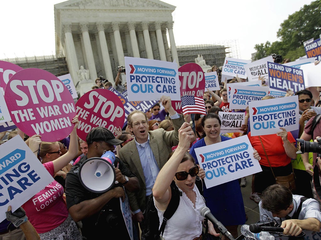 Supporters of
Mr Obama's
Affordable Care
Act celebrate
the ruling
outside the
Supreme Court
