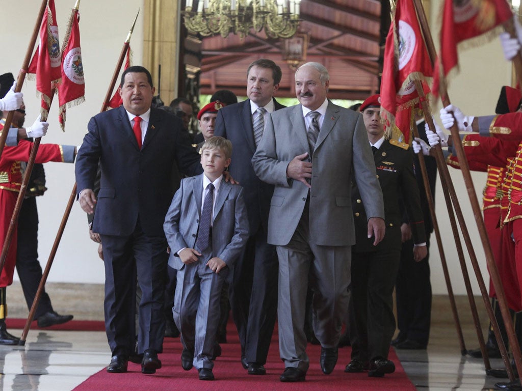 Kolya Lukashenko, flanked by Venezuela's leader Hugo Chavez and his father, President Alexander Lukashenko, in Caracas this week