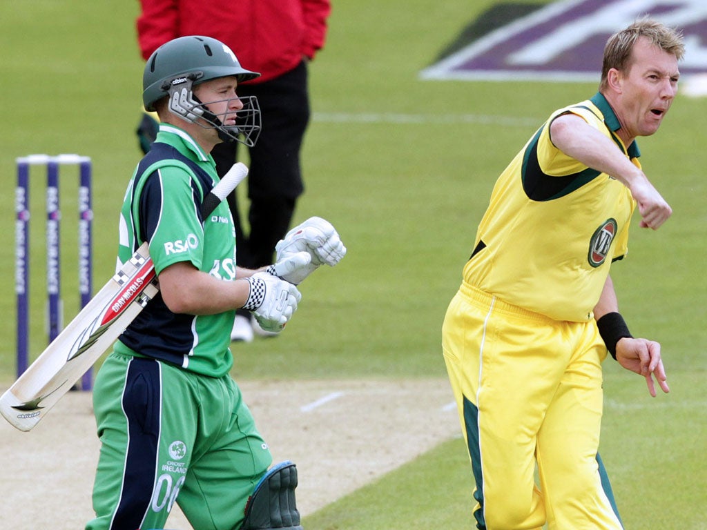 Australia's cricketer Brett Lee (R) celebrates after bowling out Ireland's William Porterfield on the first bowl