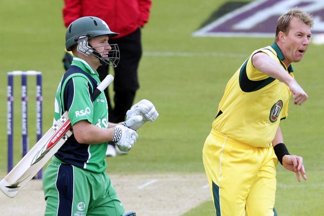 Australia's cricketer Brett Lee (R) celebrates after bowling out Ireland's William Porterfield on the first bowl 