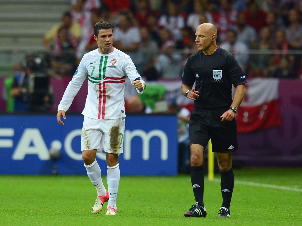 Howard Webb pictured refereeing a match involving Portugal
