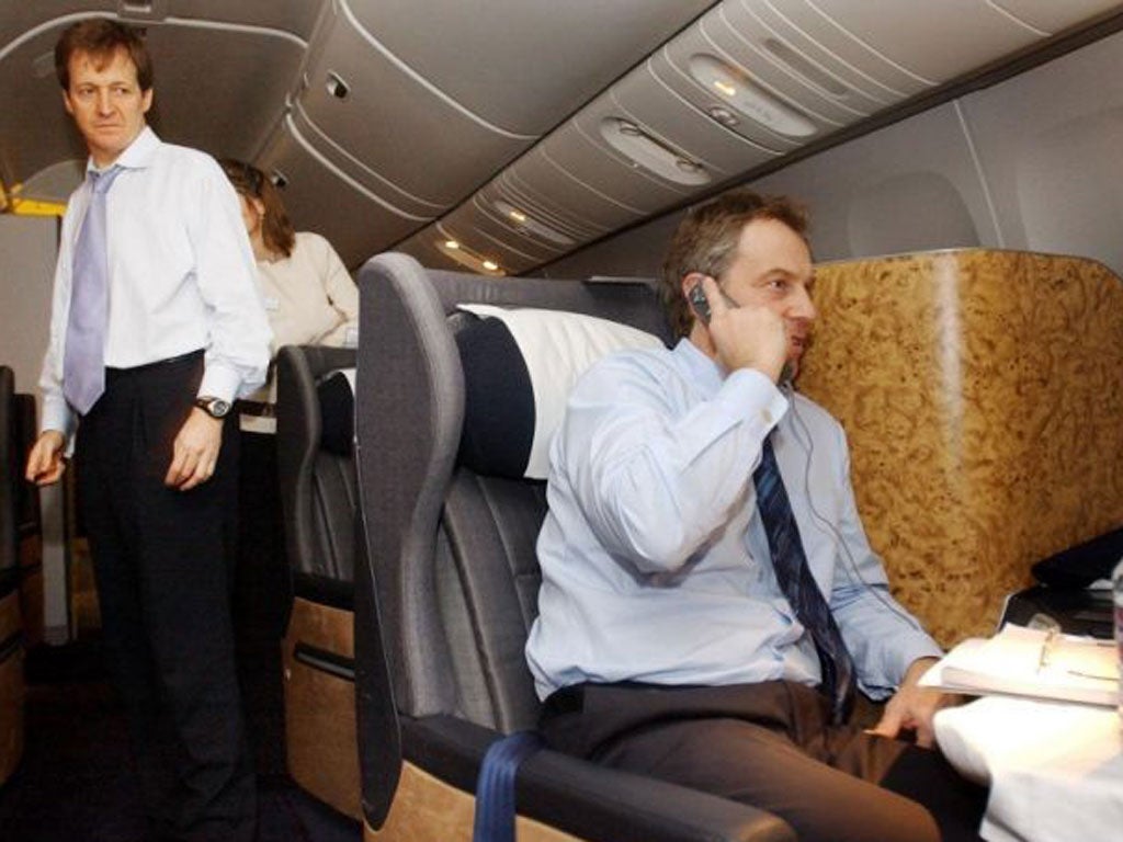 British Prime Minister Tony Blair, center, watched by his director of Communications and Strategy, Alastair Campbell, left, speaks to the Foreign Secretary Jack Straw on the telephone duing his flight back from the Azores, Sunday, March 16, 2003, after a summit meeting with President Bush and Spanish Prime Minister Jose Maia Aznar where they discussed the future of action to disarm Iraq.