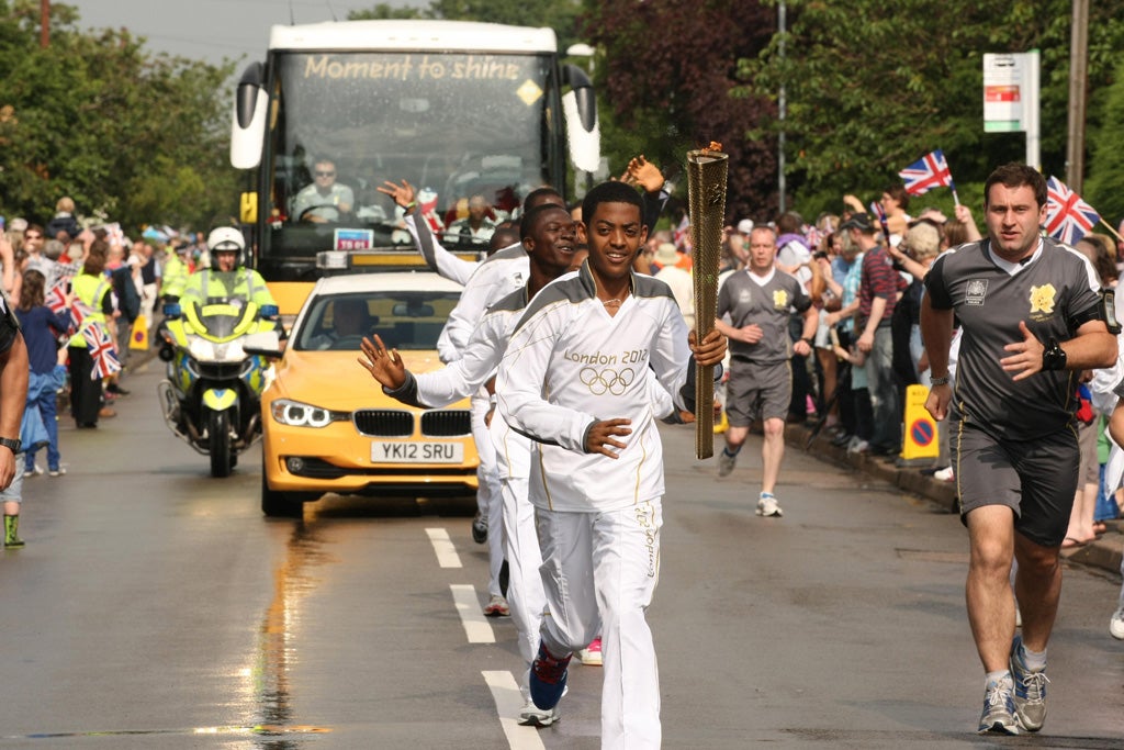 Natneal Yemane carrying the Olympic Flame on the Torch Relay leg between Radcliffe on Trent and Nottingham yesterday. Nottinghamshire Police said the 15-year-old has not been seen since leaving his hotel last night.