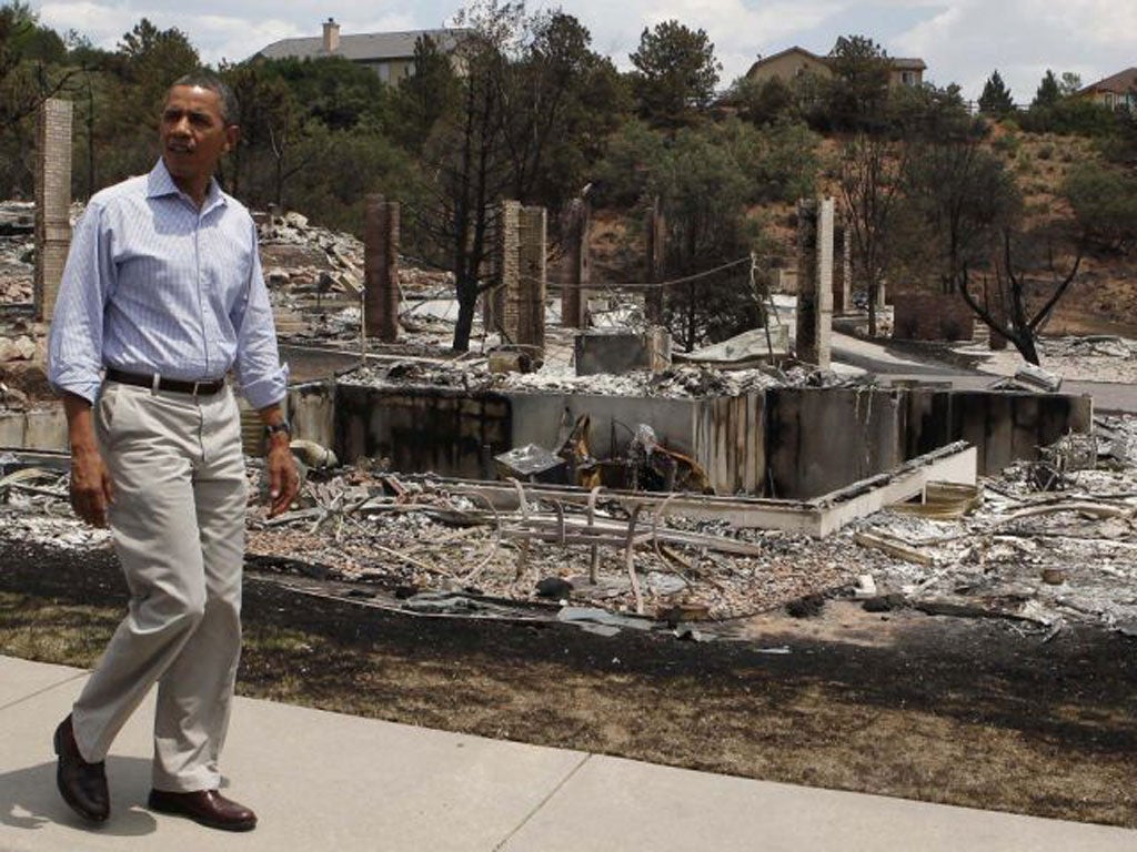 US President Barack Obama surveys fire damaged homes in the Mountain Shadow neighborhood in Colorado Springs
