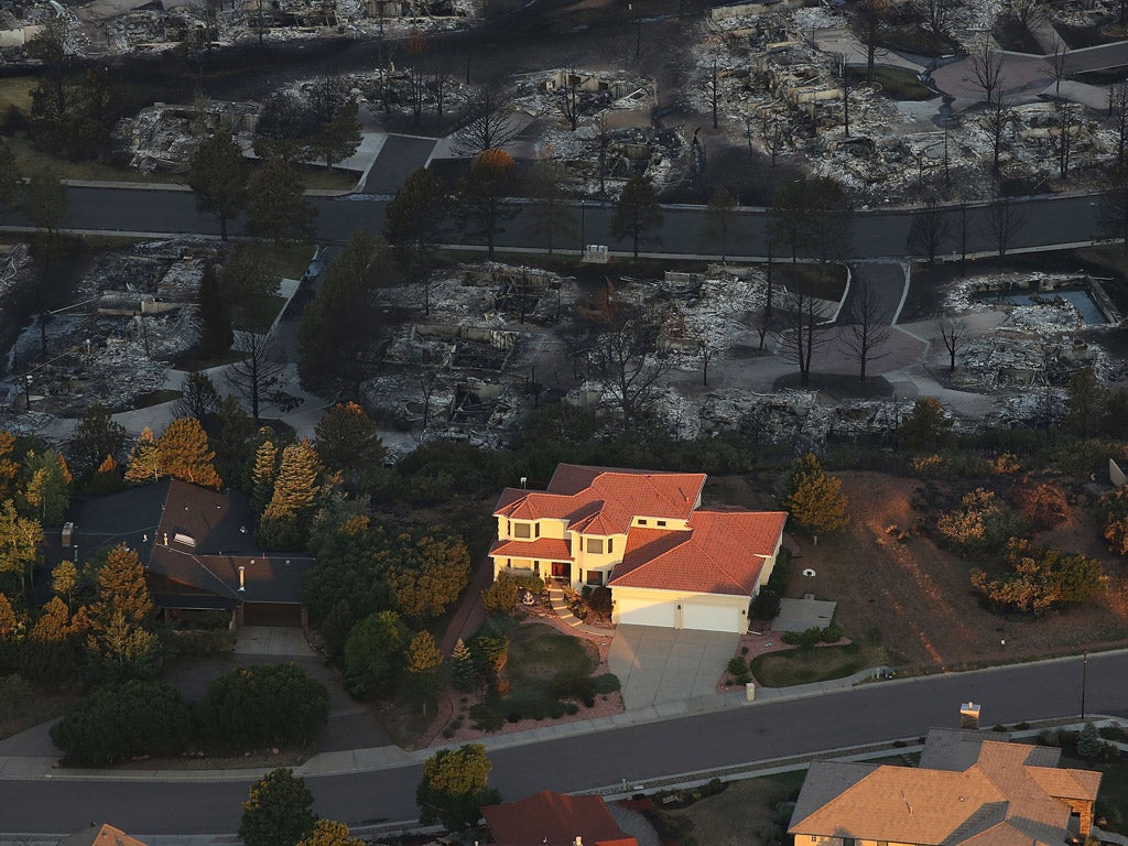 A single home in
Waldo Canyon,
Colorado, is left
unscathed by the
wildfires