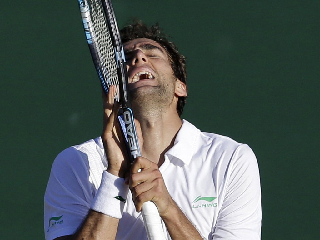 Pain of victory: Marin Cilic shows his relief as he finally beats off the challenge of Sam Querrey