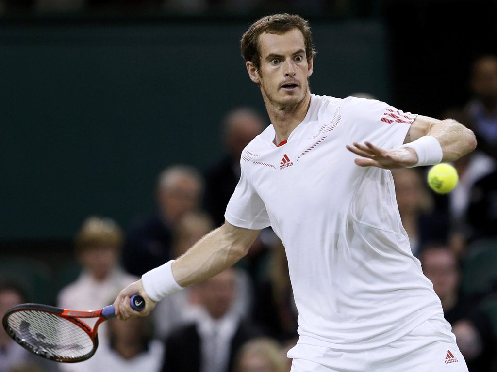 Andy Murray hits a return to Marcos Baghdatis of Cyprus