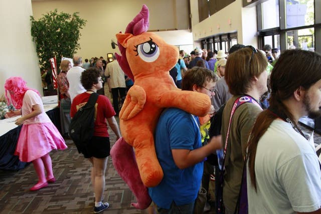 Matthew Zadonia carries a stuffed animal from the My Little Pony cartoons at BronyCon