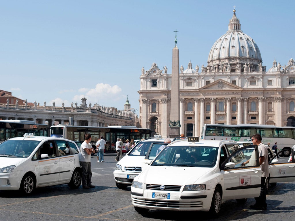 Taxis queue at a rank in front of St Peter’s Basilica in Vatican
City, Rome