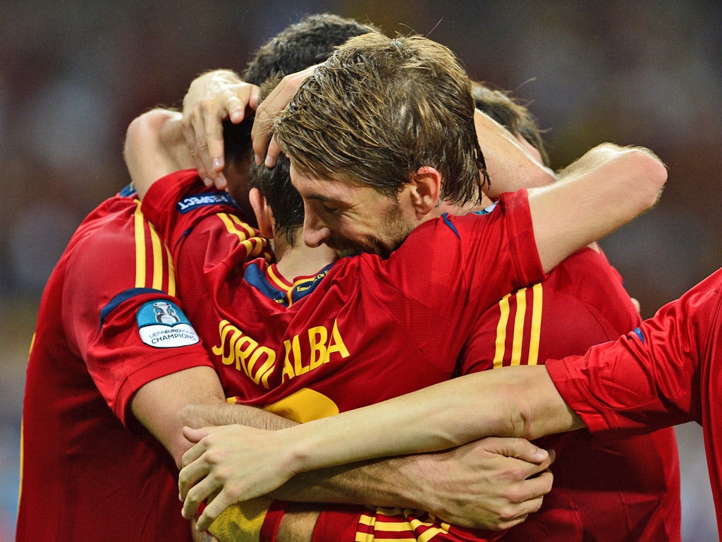 Spanish defender Jordi Alba (centre) celebrates with teammates after scoring against Italy