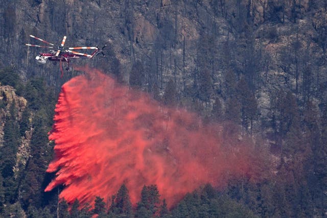 A helicopter drops fire retardant onto the Waldo Canyon Fire in
Colorado Springs yesterday