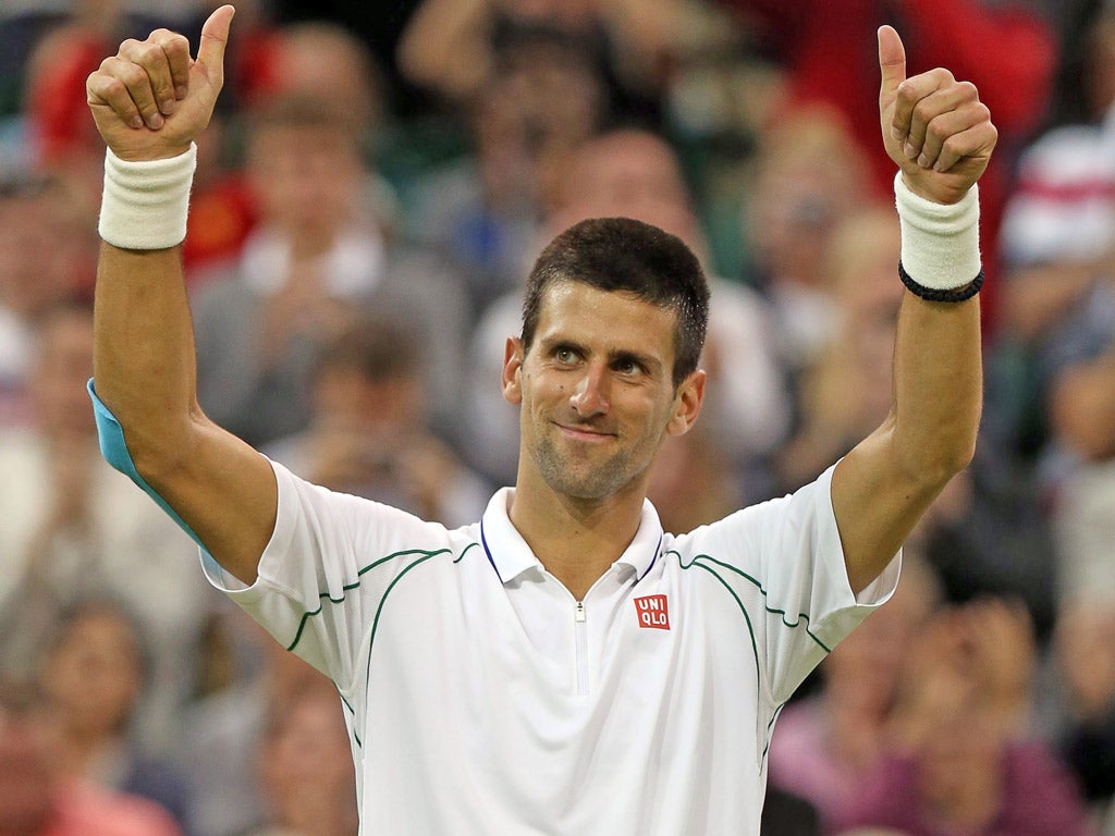 Novak Djokovic celebrates his win over compatriot Viktor Troicki in their fourth round match for the Wimbledon Championships