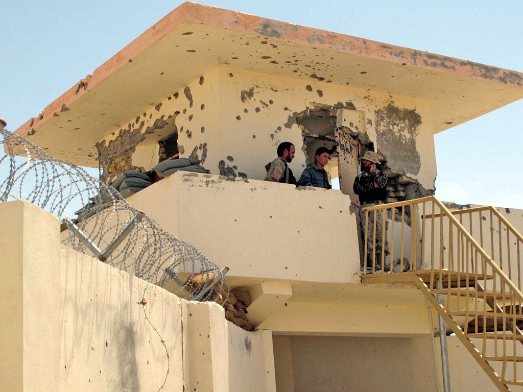 Afghan and Nato forces patrol the scene where three British
troops were killed on Sunday