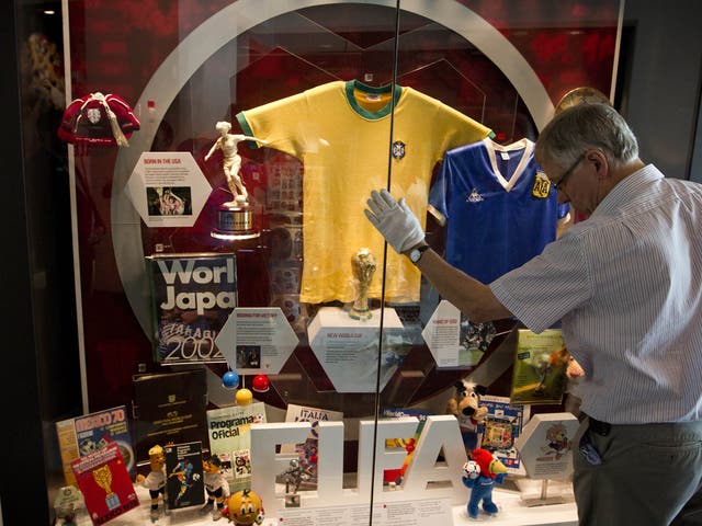 A curator puts the final touches to a display at the new football museum in Manchester
