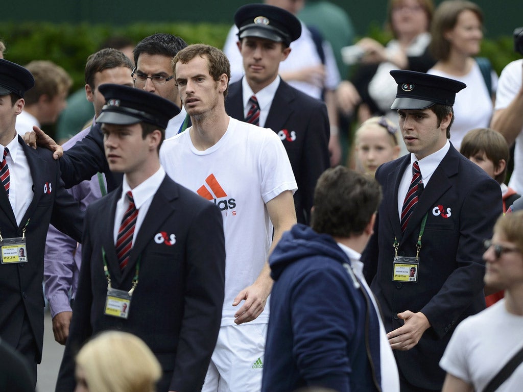 Andy Murray
is escorted to
the dressing
rooms at
Wimbledon