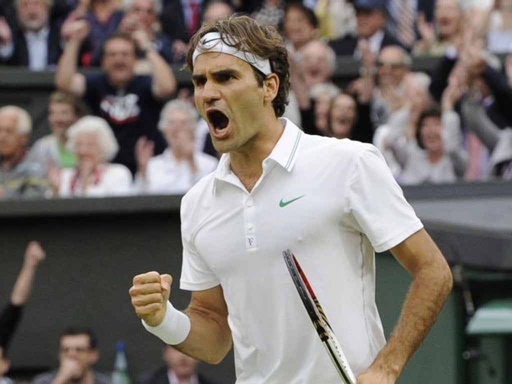Roger Federer celebrates hitting a winner during his Wimbledon semi-final against Novak Djokovic