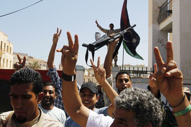 Libyan civilians and security forces celebrate Libya's first national election
