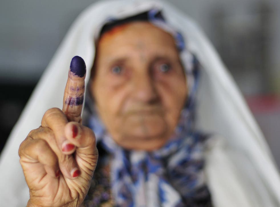 Democratic sign: A voter shows her inked finger after casting her vote in Benghazi yesterday