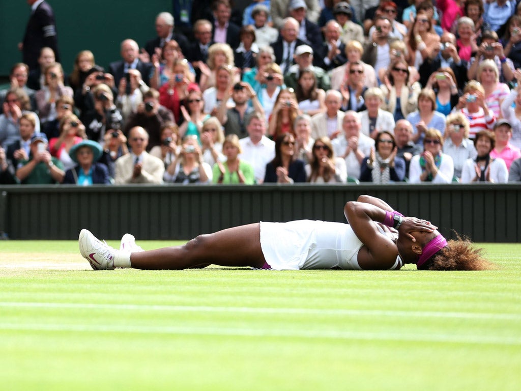 Venus envy: Serena Williams celebrates after equalling her sister Venus's record haul of five singles titles at Wimbledon