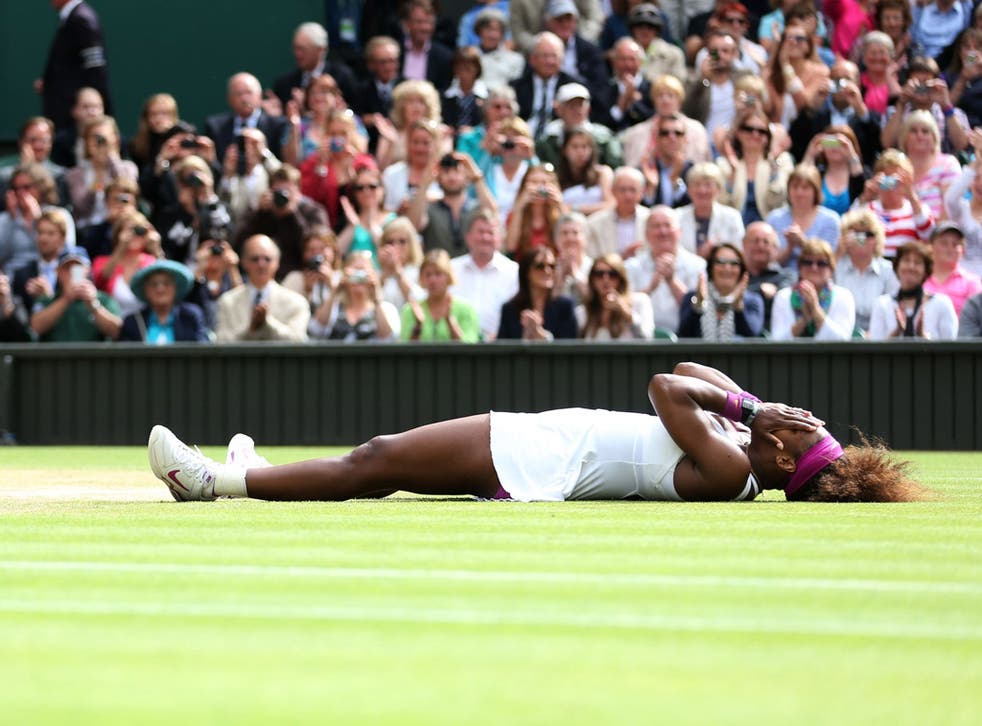 Venus envy: Serena Williams celebrates after equalling her sister Venus's record haul of five singles titles at Wimbledon