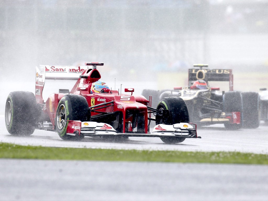 Rain dance: Fernando Alonso qualifies fastest in the wet at Silverstone for today's British Grand Prix