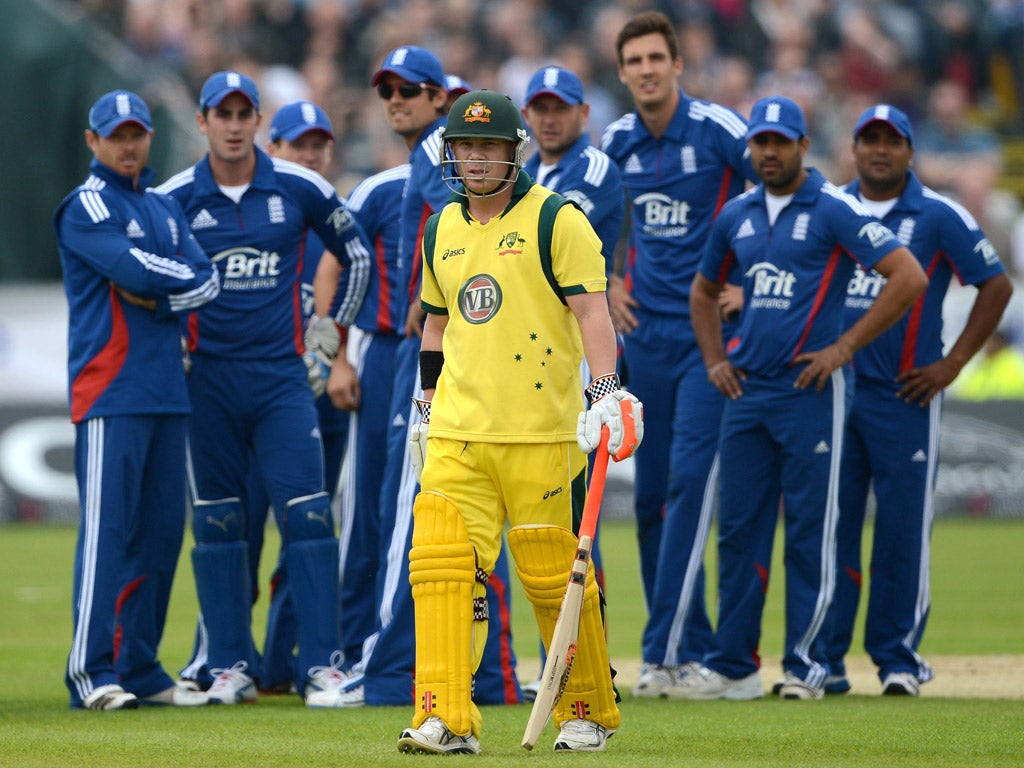 Crowded out: Australia batsman Dave Warner leaves the field in Durham, under the gaze of the England team