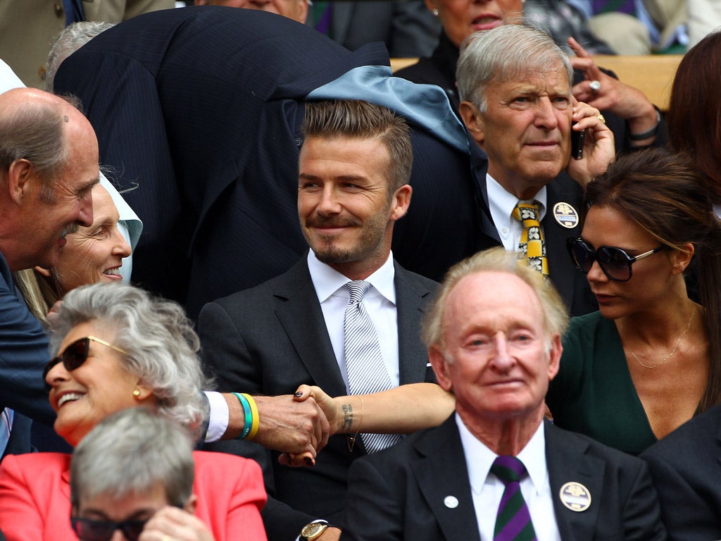 Rod Laver sits in front of David Beckham yesterday