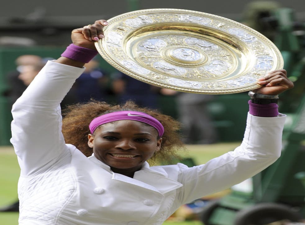 Serena Williams holds the trophy after her women's singles victory