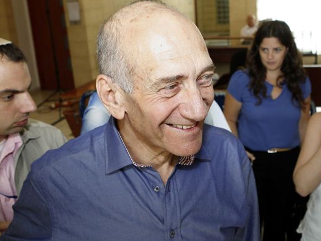 Former Israeli Prime Minister Ehud Olmert is jubilant as he leaves Jerusalem District Court