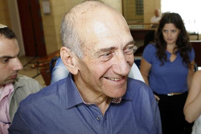 Former Israeli Prime Minister Ehud Olmert is jubilant as he leaves Jerusalem District Court