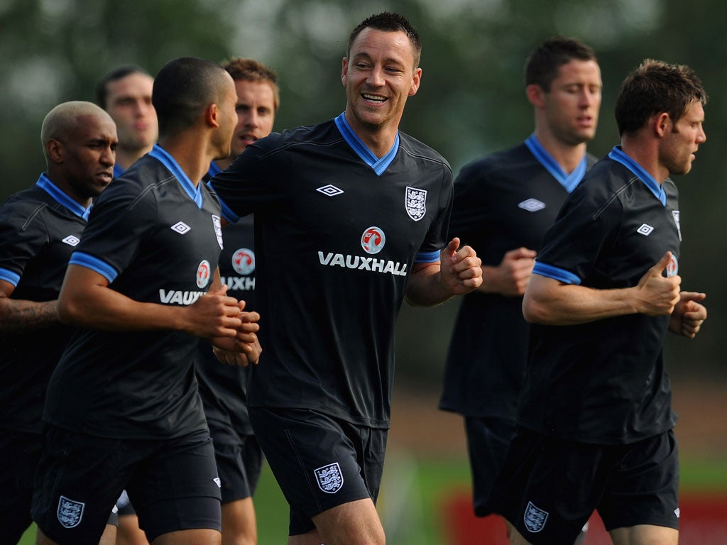 John Terry jokes with Theo Walcott during England training