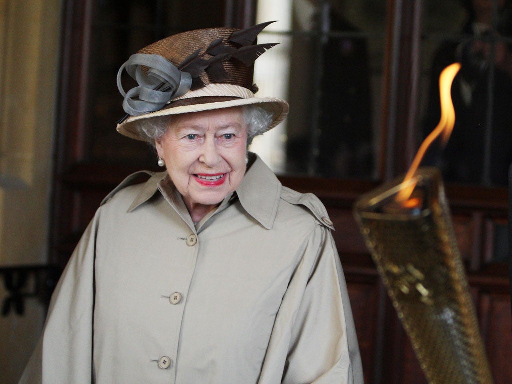 The queen is shown the Olympic flame