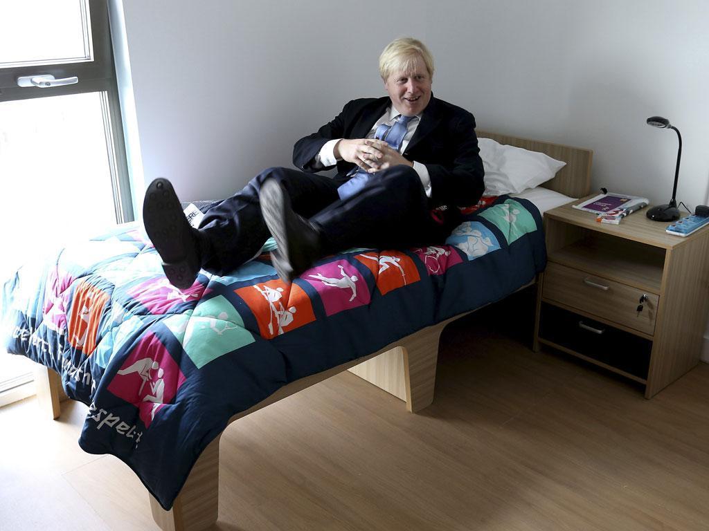 July 12, 2012: Mayor of London, Boris Johnson, tests out a bed during his visit to the 2012 Olympic Park and Olympic Village in London.