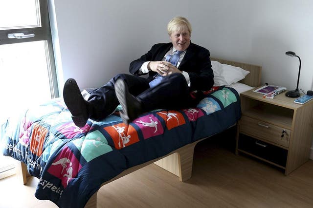 July 12, 2012: Mayor of London, Boris Johnson, tests out a bed during his visit to the 2012 Olympic Park and Olympic Village in London. 