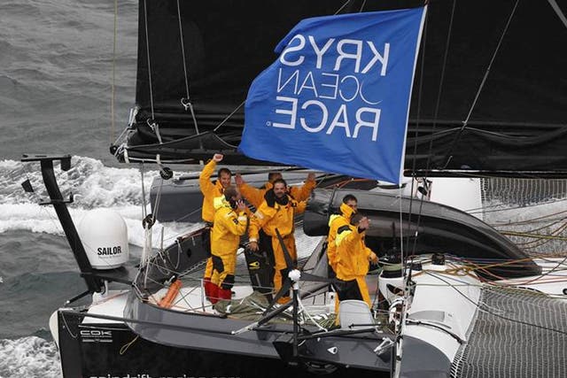 All smiles as Yann Guichard and the crew of the 70-foot trimaran Spindrift cross the finish of the Krys Ocean Race from New York to Brest