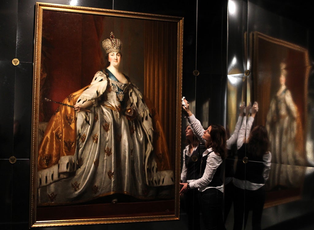 Esther Lynn, from the National Museum of Scotland in Edinburgh, puts the finishing touches to an oil painting of Catherine II in her Coronation Robes by Danish artist Vigilius Eriksen painted after 1762, which makes up part of the Catherine the Great: An