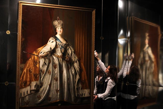 Esther Lynn, from the National Museum of Scotland in Edinburgh, puts the finishing touches to an oil painting of Catherine II in her Coronation Robes by Danish artist Vigilius Eriksen painted after 1762, which makes up part of the Catherine the Great: An 